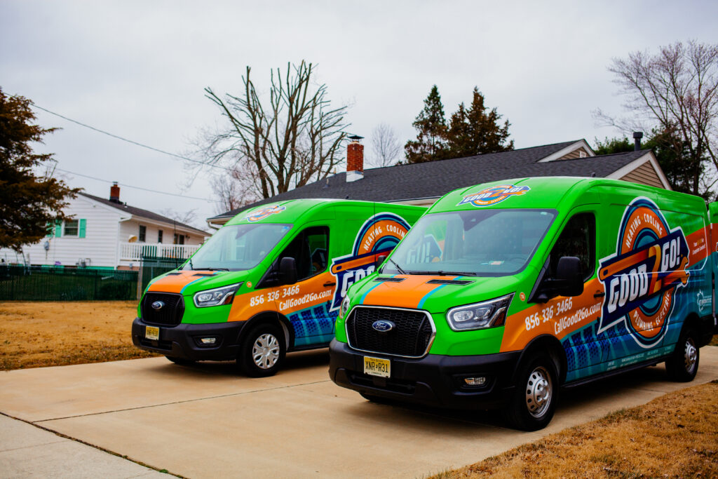 Two Good2Go service vans parked in a residential driveway, representing trusted HVAC, plumbing, and electrical services for homeowners in Salem County, NJ.